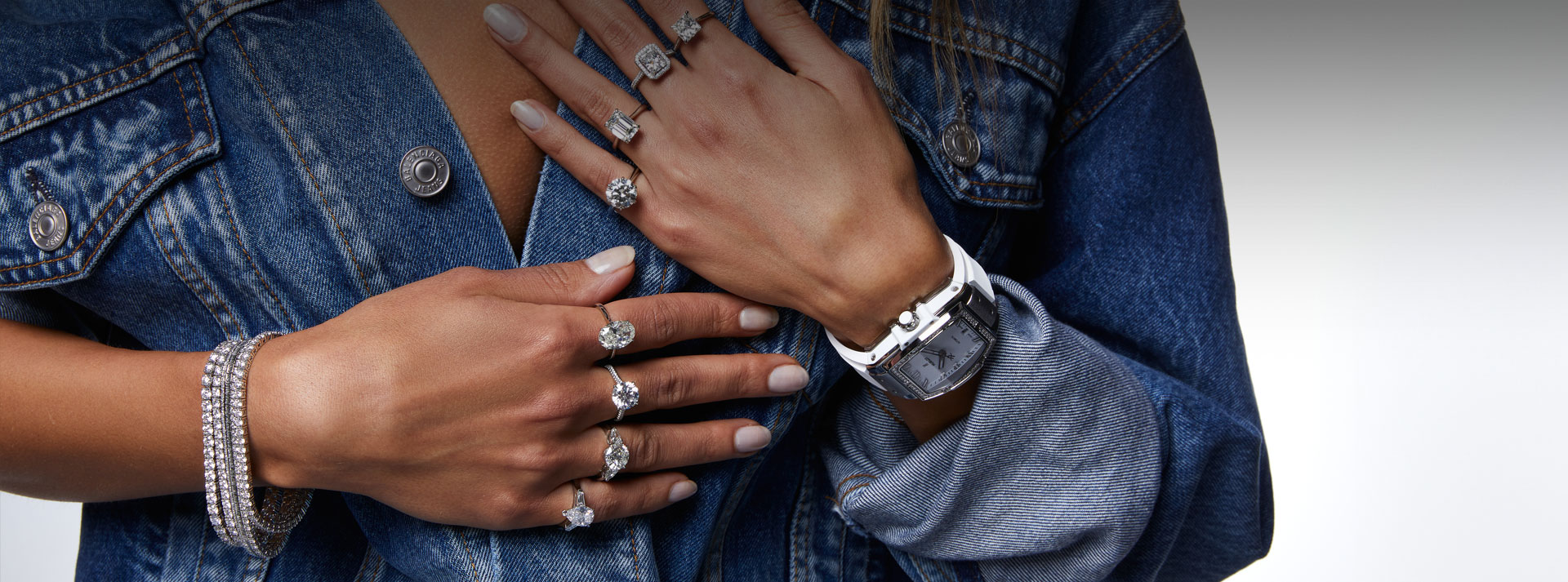 woman wearing multiple diamond rings